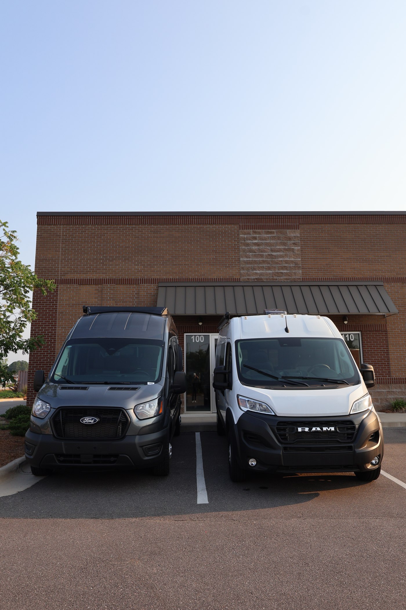 Ford Transit AWD and Ram ProMaster parked side by side at the Vantra shop