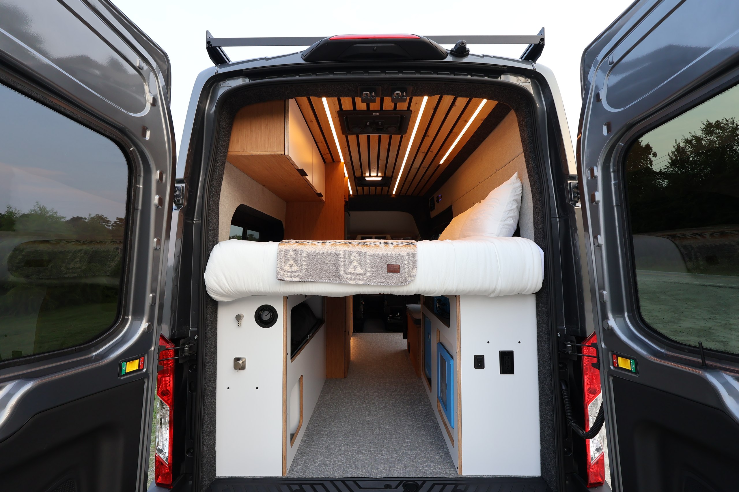 View into the Vantra camper van through the open rear doors