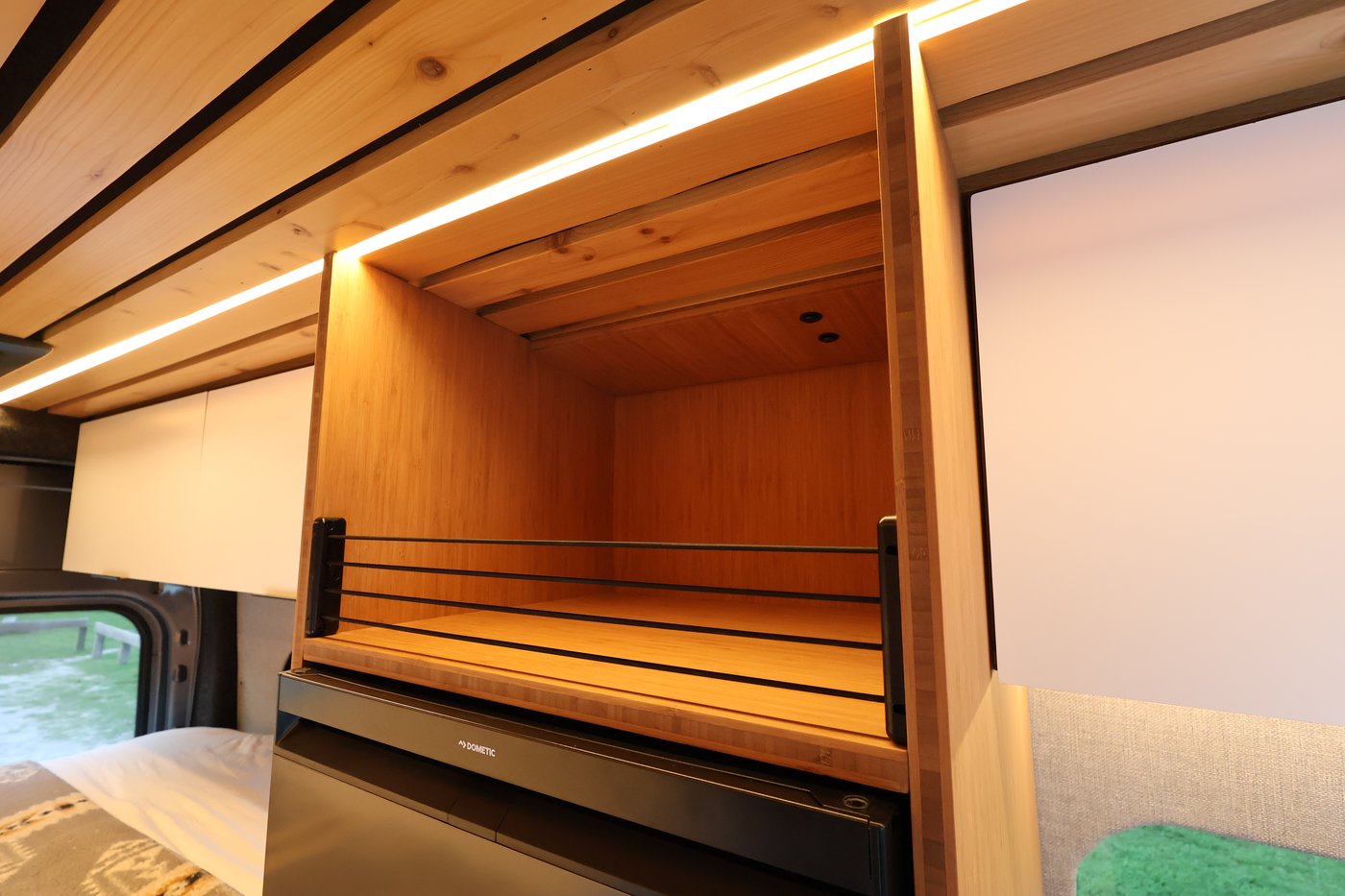 Storage compartment inside the Aire floor-to-ceiling cabinet