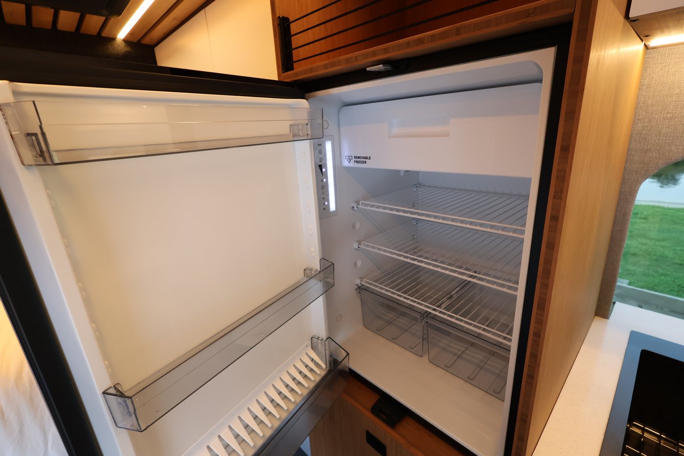 Dometic refrigerator installed in the Aire floor-to-ceiling fridge cabinet