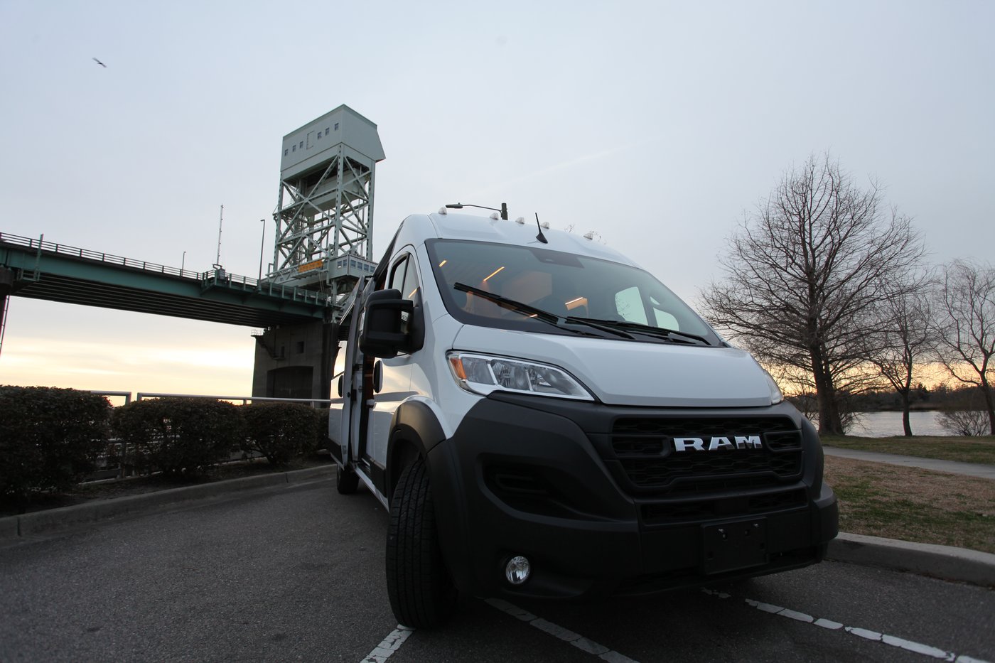 Vantra Atlas camper van on a Ram ProMaster, front view with bridge in the background